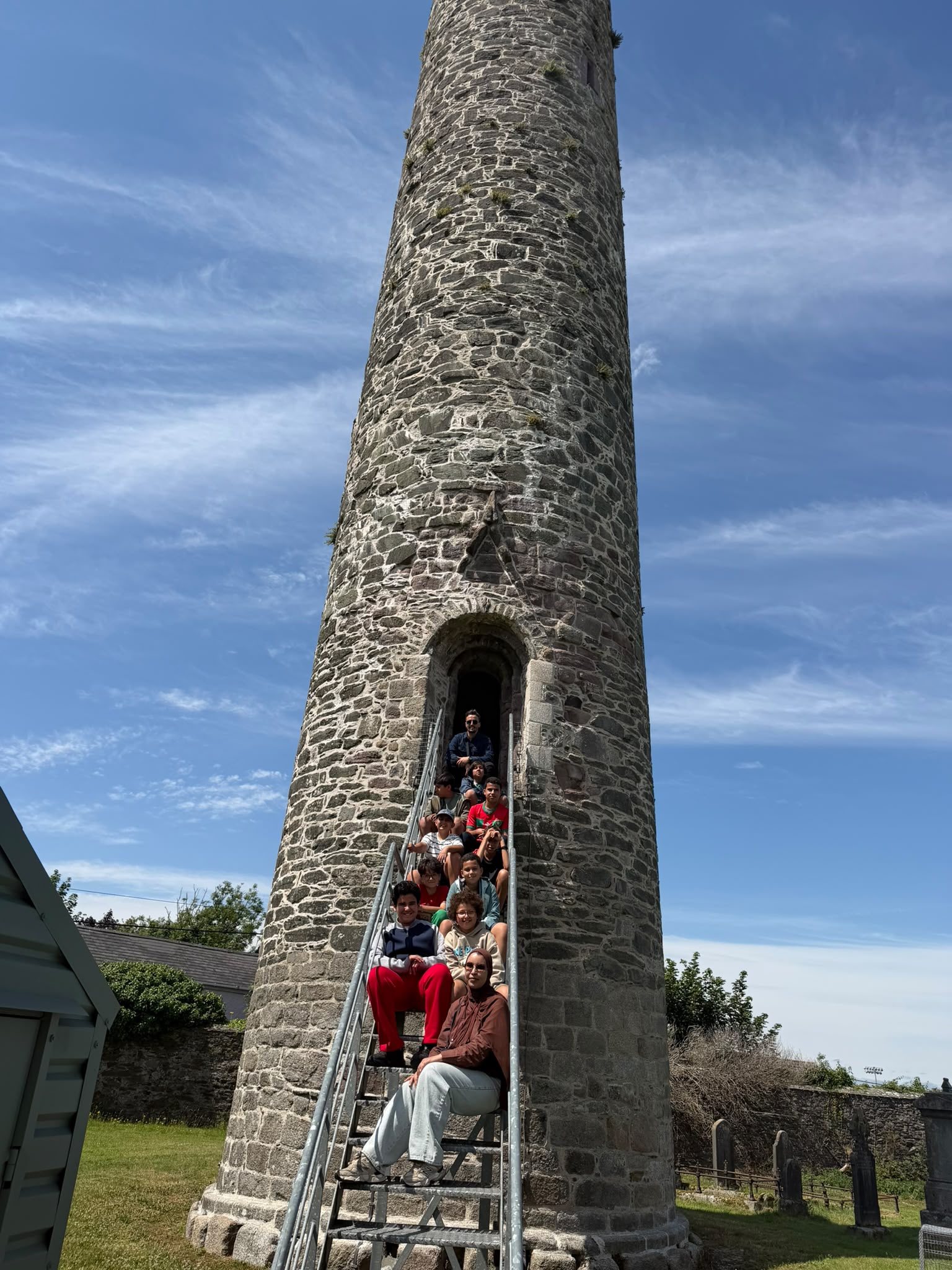 Students exploring an Irish round tower